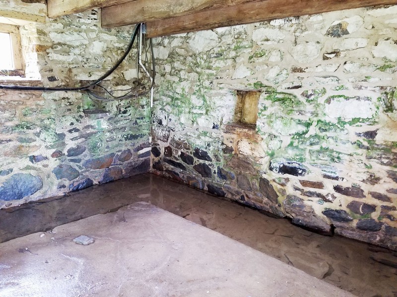 The first floor of the springhouse with the spring still flowing through it