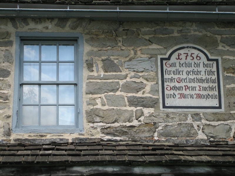 A traditional German house blessing was placed just above the porch roof of the house.