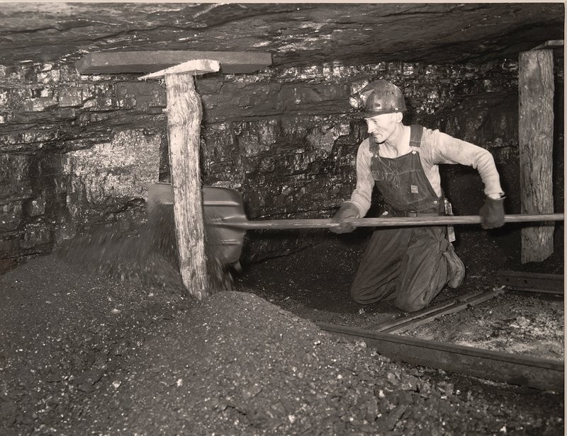 A Miner Shoveling Coal 