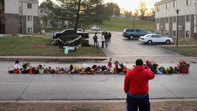 In the street where Michael Brown Jr. was fatally shot, passersby have left tokens of remembrance. This photo depicts stuffed toys and flowers which are often left to remind others that Michael was still a child at his death.