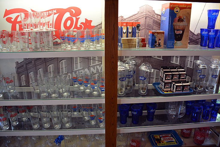 This is a variety of soda bottles and Pepsi memorabilia in Bradham's Pharmacy.