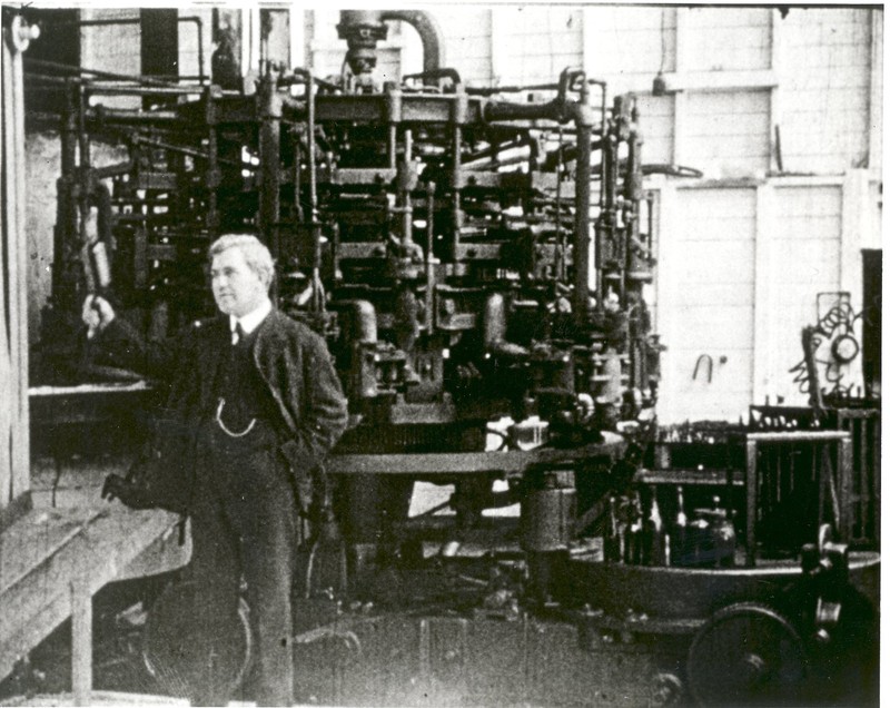 Photo of Michael Owens with his bottle-making machine c. 1910. Photo from utoledo.edu