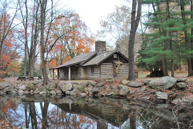 Exterior view of log cabin from the creek