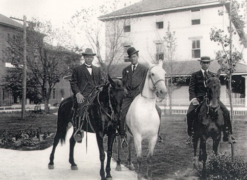 Booker T. Washington and sons on horseback