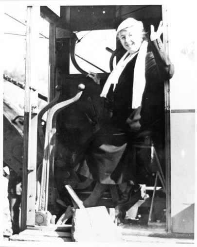 Mrs. Helen Wilson, who, with her husband Luke Wilson, donated the first land for the NIH campus at Bethesda, waves from an excavator on January 11, 1938.  She is wearing Black because of her husband’s death in August, 1937.