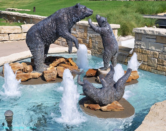 "The Bear Pit" shows a mother bear attending to one cub, while the other tries to catch a fish. The sculptures are surrounded by a pool of water from the fountain. From G O'Graffer on Flickr.