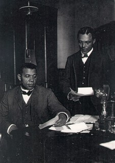 Booker T. Washington and his private secretary, Emmett J. Scott in his office, 1902