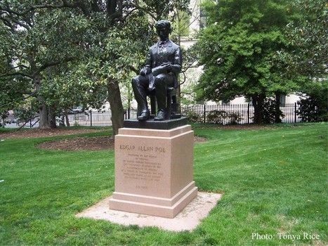 In the statue, Poe is seen sitting in a chair and reading a book. There are more books stacked underneath the chair. His birth and death dates are inscribed on the back of the granite base.