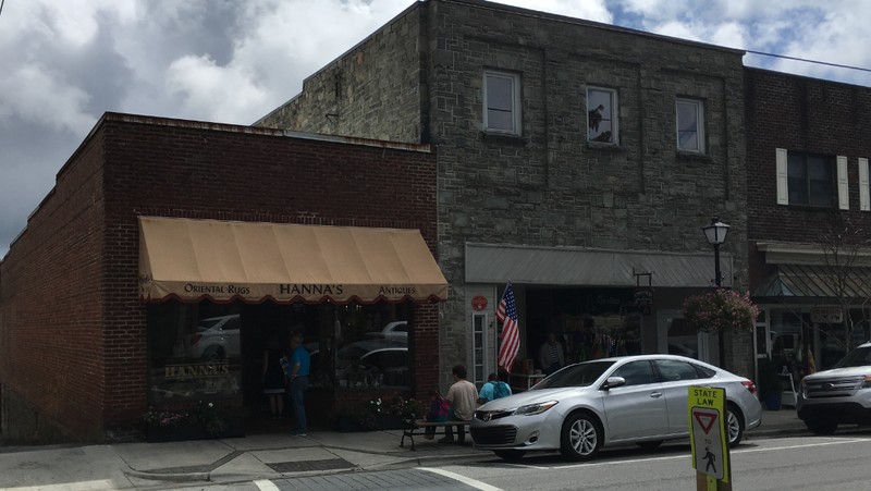 The original Hanna's building is the brick building with the awning on the left. The stone building on the right is the Yonahlossee Theater building. Photo 2018