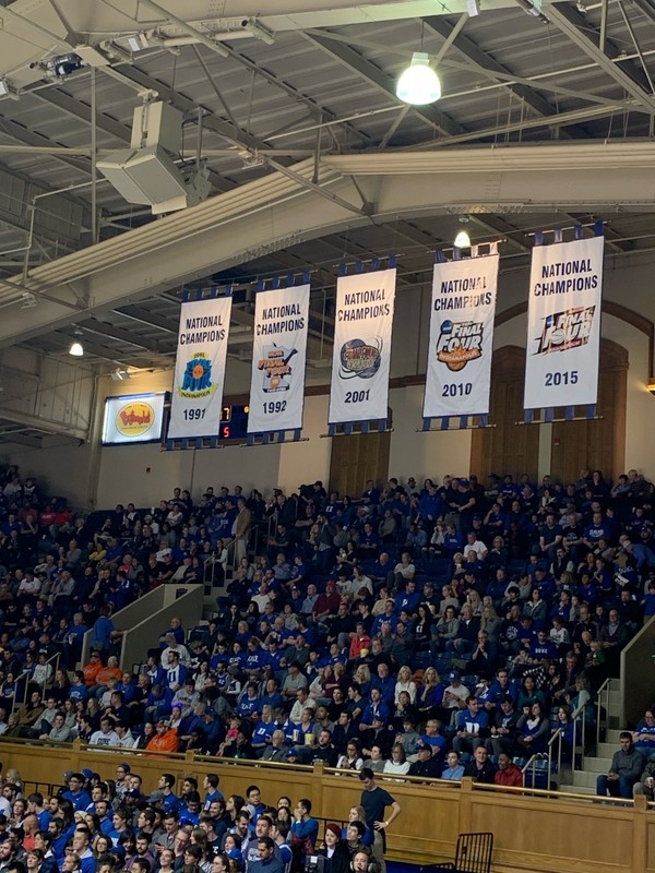 In addition to the retired jerseys, 5 banners hang on the opposite end of the gymnasium symbolizing the 5 National Championships won by each Duke program.