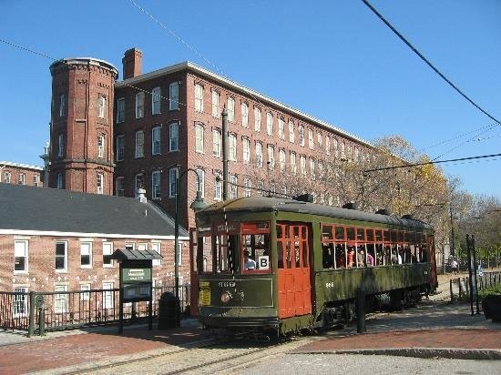 An exterior picture with a trolley tour passing by