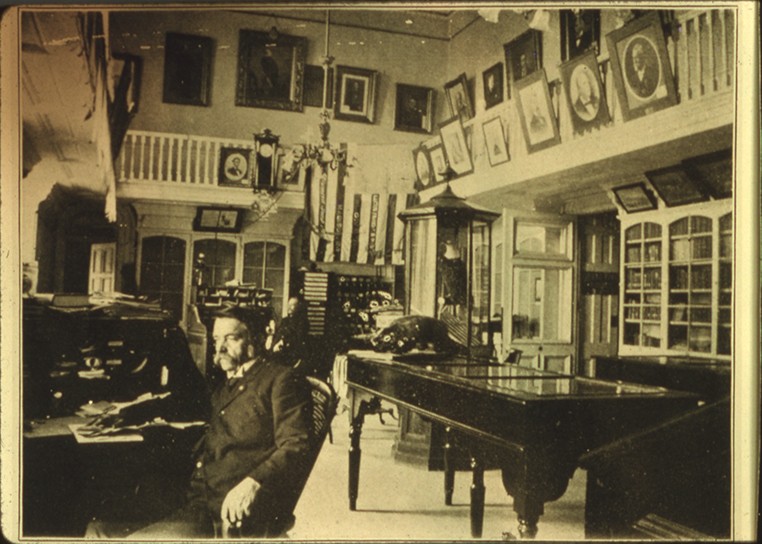 Grand Army of the Republic Memorial Hall, including custodian Hosea Rood and the collection of the GAR Memorial Hall.  This image is of the Hall and collections before the Wisconsin State Capitol burned down in 1904. 