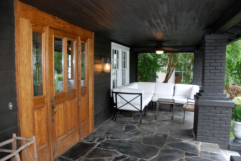 The front porch showcases original brick pillars, front door with sidelights, and flagstone flooring. Photo credit: Jesse Wood, HCPress.com