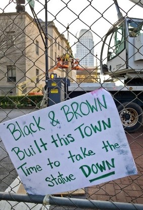 Sign placed on fencing where workers were preparing to remove the monument.