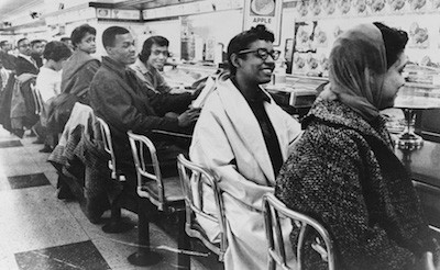 Sit in protesters sitting at the lunch counter in defiance of the store's policy of racial discrimination.