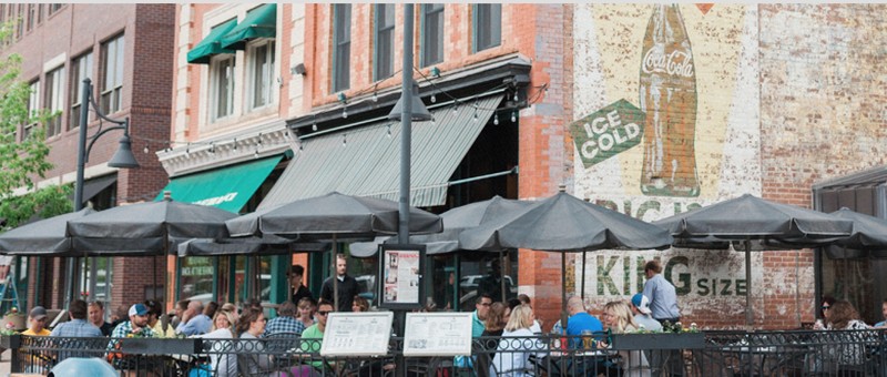 Patio of the Pubside, including the untouched Ghost signs of historic Old Town Square. (Courtesy of Coopersmithspub.com)