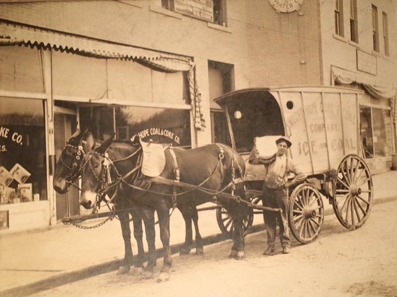 Prior to opening the Cobbler Shop and Confectionery in 1920, the buildings were used by the Mount Hope Coal and Coke Company.  Viewed in the front of the building is an ice delivery service.