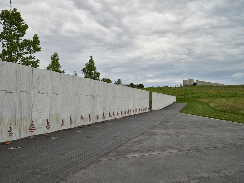 The Wall Of Names, consisting of forty white marble pieces leading along the final approach of Flight 93. Each piece of marble is inscribed with the name of one of the passengers or crew members, ending with a final piece of granite etched with the time that the plane crashed into the field. They collectively point the way to a sandstone boulder which marks the impact site of the plane.