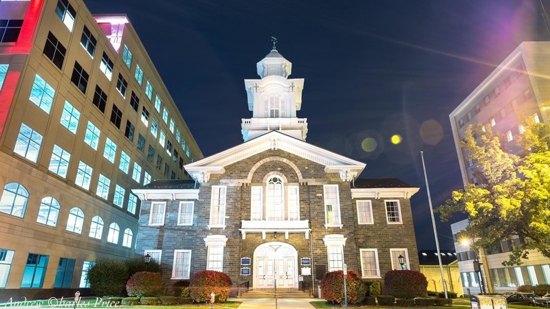 The Old Courthouse at night, surrounded by the modern buildings of Allentown.  
