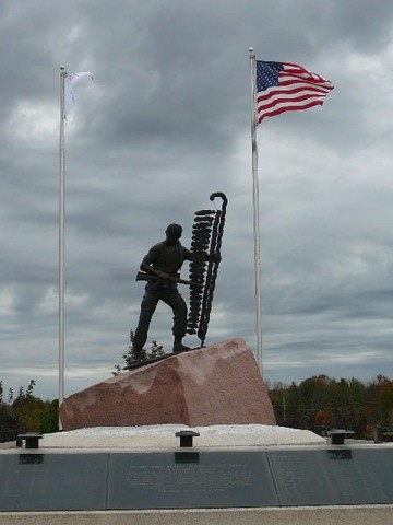 View from the front of the monument, showing the soldier with an M16 rifle and planting an eagle feather staff