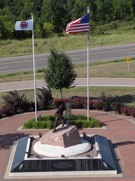 Aerial photo of the entire monument also showing the flags of the United States and a Native American tribe 