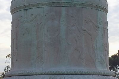 The base of the statue contains lightly sculpted images of Francis Scott Key, as well as other important figures from Greek mythology. This type of light sculpting into a horizontal medium is called a frieze in light relief. From The Historical Marke