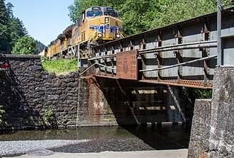 A diesel engine approaching Multnomah Falls bridge.