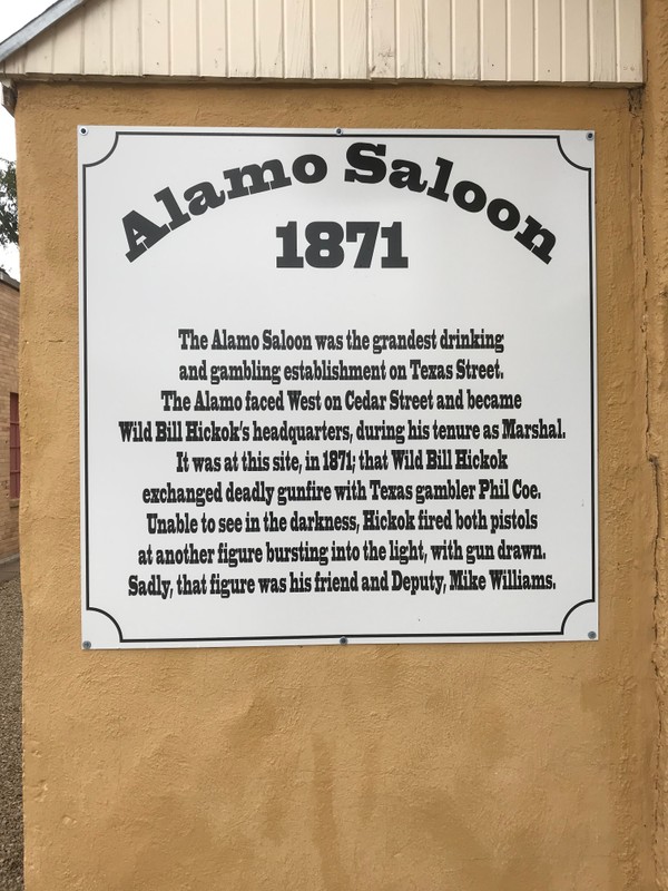 Commemorative sign at the original site of the Alamo Saloon on the corner of N Cedar St. and W 1st St.