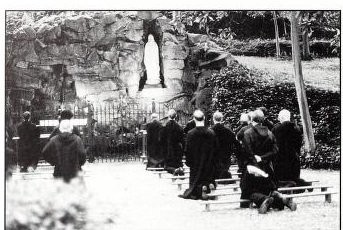 Monks of Belmont Abbey praying at the Our Lady of Lourdes Grotto. Source: Fr. Paschal Baumstein, OSB, Blessings in the Years to Come: Belmont Abbey, A Pictorial Perspective (Belmont, NC: Belmont Abbey Archives, 1999)