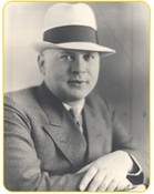 Portrait of Whitey Larson wearing a business suit and tie and bowler hat.