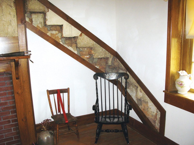 Original walls showing where a staircase was located was discovered when the paneling was removed in the Hugh’s Room