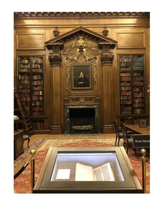 2018 view inside the Harry Elkins Widener Memorial Reading Room. Note the Gutenberg Bible in the foreground and the portrait of Harry Elkins Widener above the mantle.