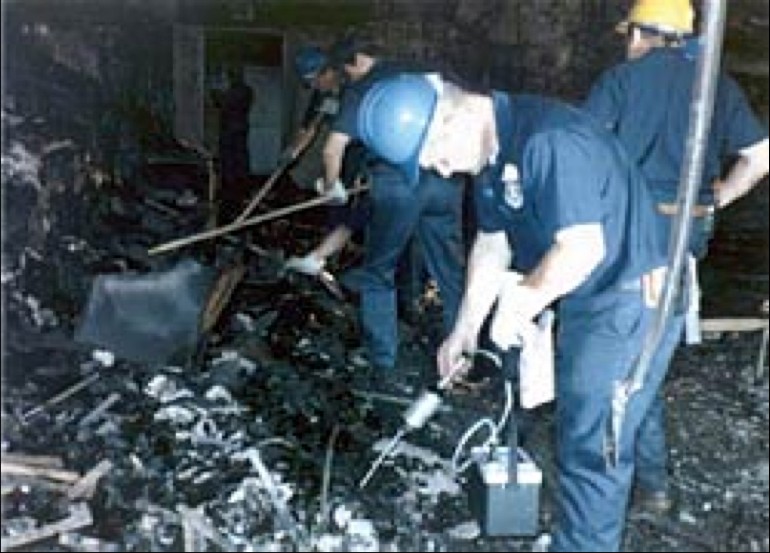 This picture depicts the aftermath of the Dupont Plaza Hotel arson. As seen, responders fled to the scene after the extinguishment of the fire. In the hotel itself, the responders and agents sifted through the burned ash and rubble in order to find remain