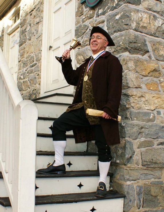 The Easton town crier on the steps of the Bachmann Publick House. 