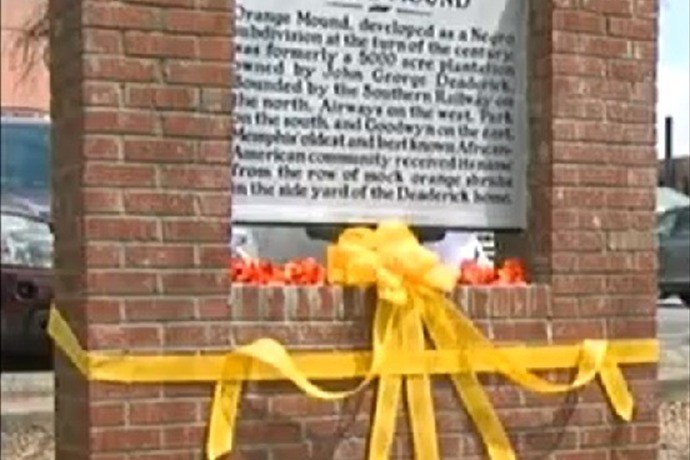 When vandals took the original historical marker, the community raised funds and created a new marker and a brick wall to protect it.