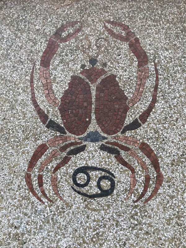 An image of a red crab formed from small tiles.