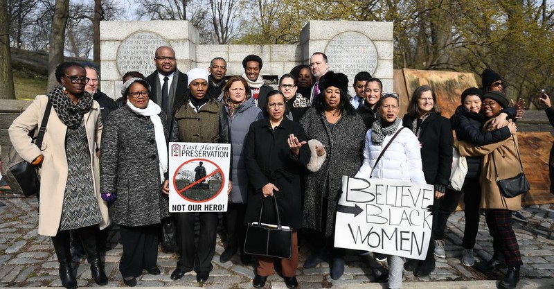 In good spirits, members of the East Harlem Preservation stand in front of the newly removed statue.