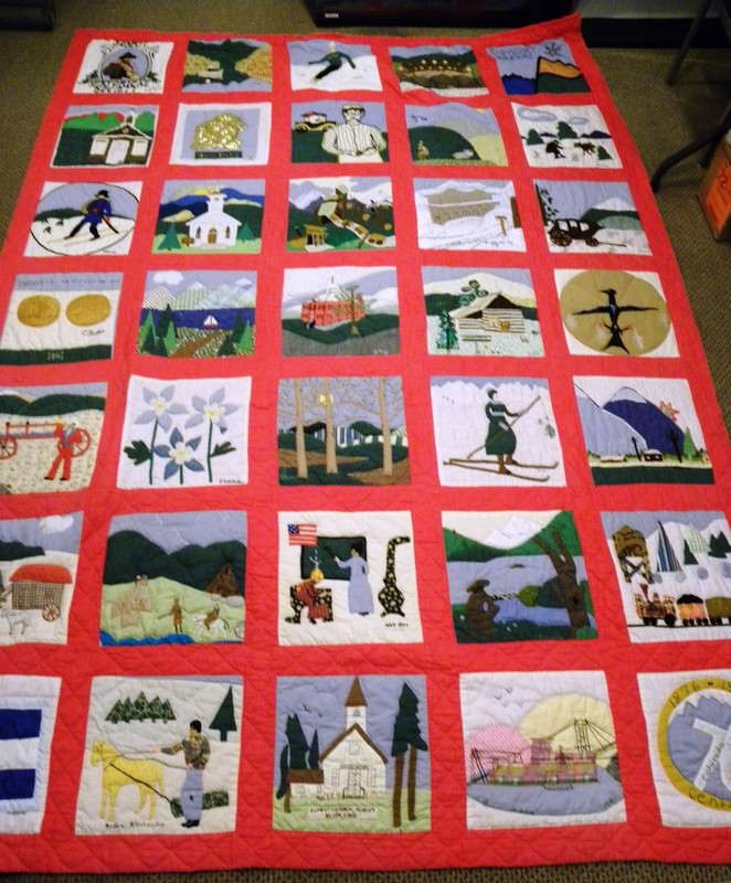 A quilt crafted for the 1976 Colorado Centennial celebration raffle. It has 35 quilted blocks depicting Summit County and Colorado motifs. Most blocks have the signature of the sewer. 