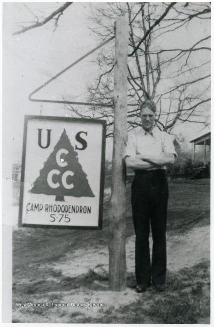 A Camp Rhododendron member with a CCC sign