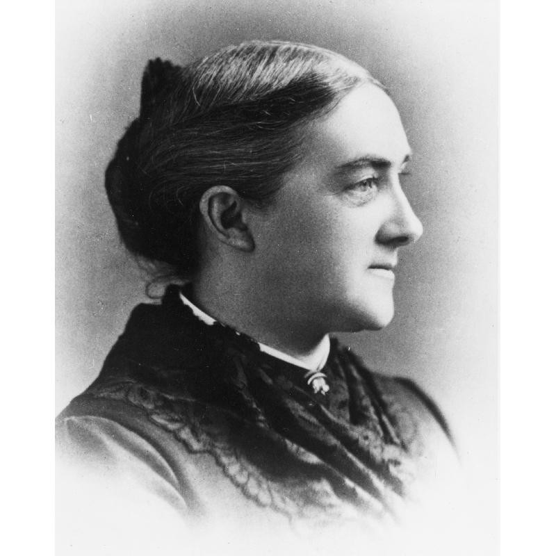 Headshot in profile of a young Ellen with dark hair and dress, hair pulled back.