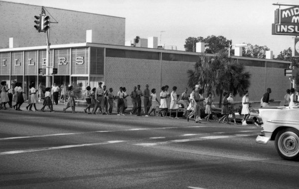 Students on the northeast corner of Monroe and College lined up on their way to police wagons that took them to jail on May 30, 1963. 