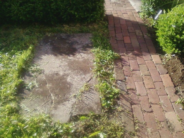 Brick Sidewalk next to a Grave