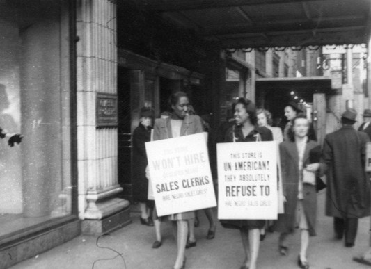 Women protesting Gimbels Department Store for refusing to hire Black women.