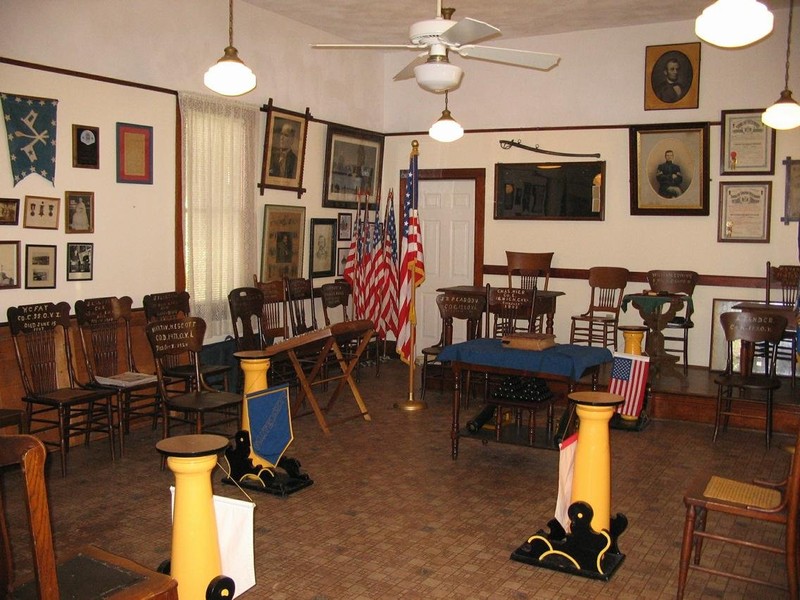 The hall features original chairs and memorabilia displayed on the walls.