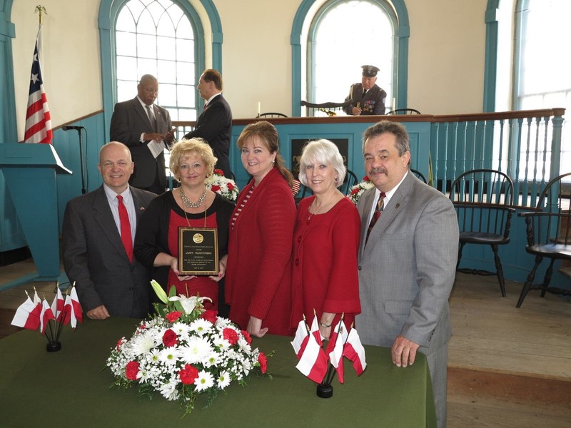 A group of dignitaries inside the courthouse.  The judge's bench once occupied the space directly behind them.