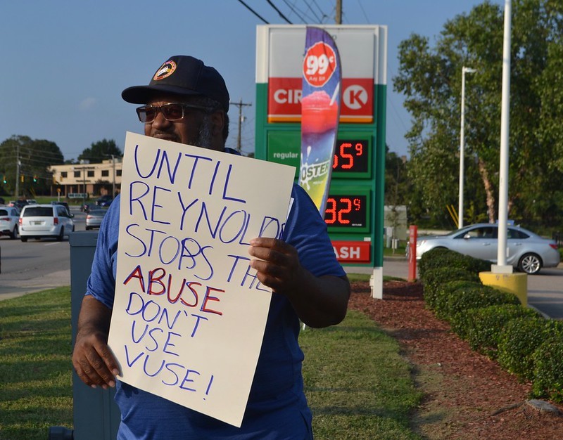 FLOC member holding sign to boycott Vuse.