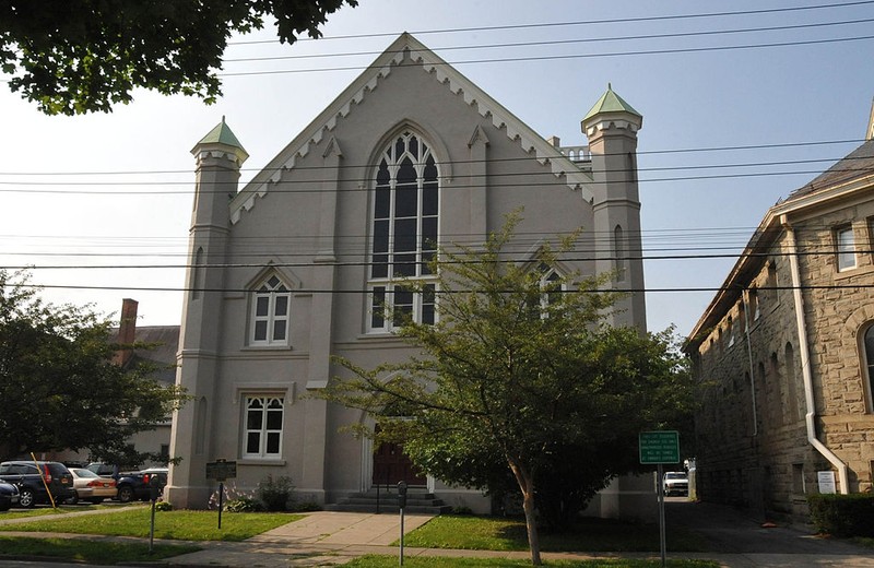 The Second Tompkins Courthouse was built in 1854. The most notable exterior feature of this building is a three-story tower that contains a belfry with a pointed-arched opening similar to bell towers that appear in many churches. 