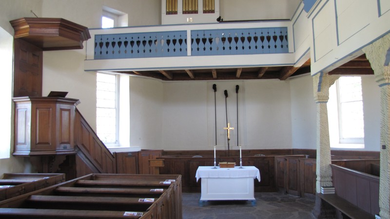 The church's interior, notice the red walnut pulpit on the left and organ loft which was added in 1752.