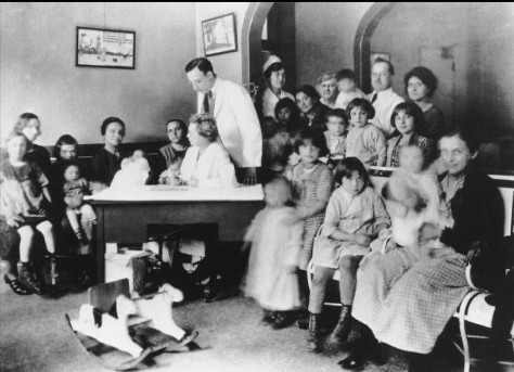 Dr. Florence Seibert sitting at a desk in the Phipps Institute Children’s Clinic in Philadelphia, PA.  