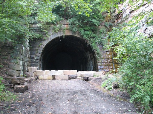 This is one of the entrances to Brady's tunnel which was in operation from 1916 until 2010 when Land Trust bought the railroad corridor and tunnel.